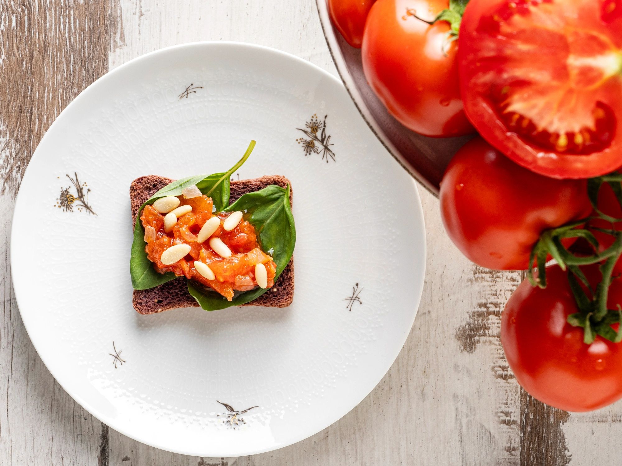 Italian bruschetta appetizer topped with tomatoes and basil
