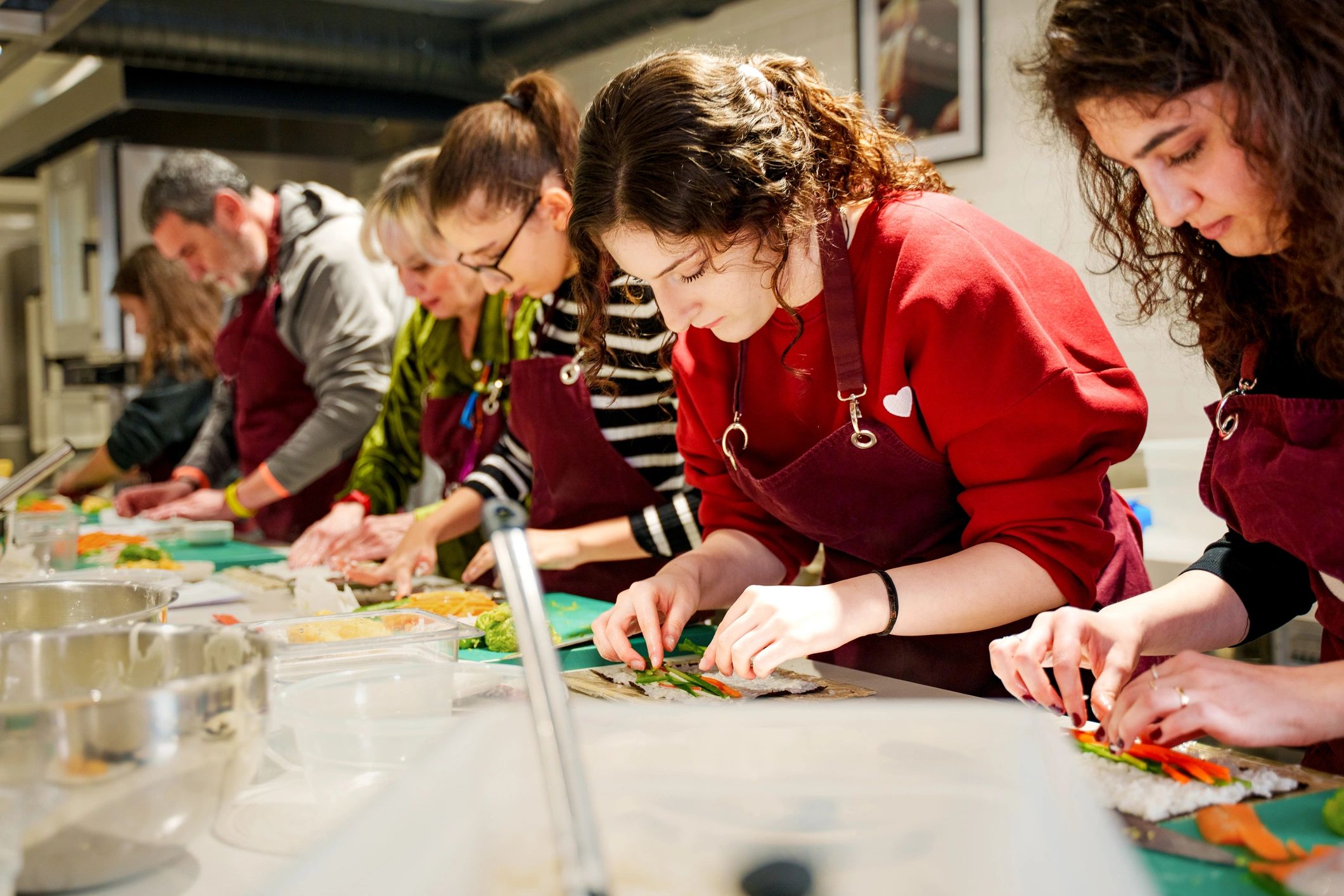 Group cooking together and preparing ingredients