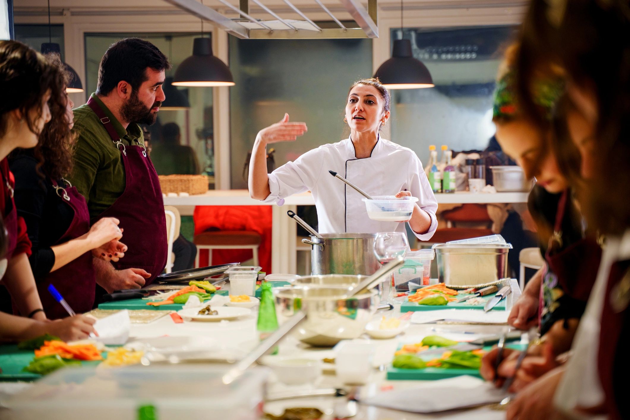 Chef teaching a cooking class in a modern kitchen